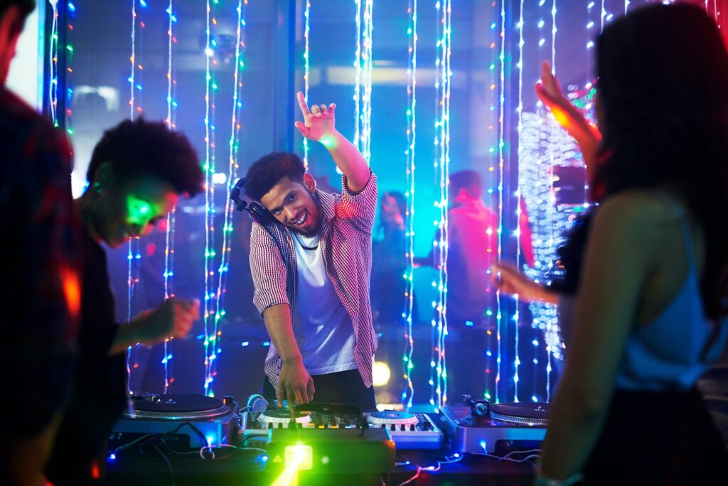 Bringing the beats. Portrait of a happy young DJ playing music at a party in a nightclub.